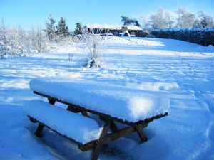 picture of Foot of snow on picnic table - click for larger image. Opens in new tab